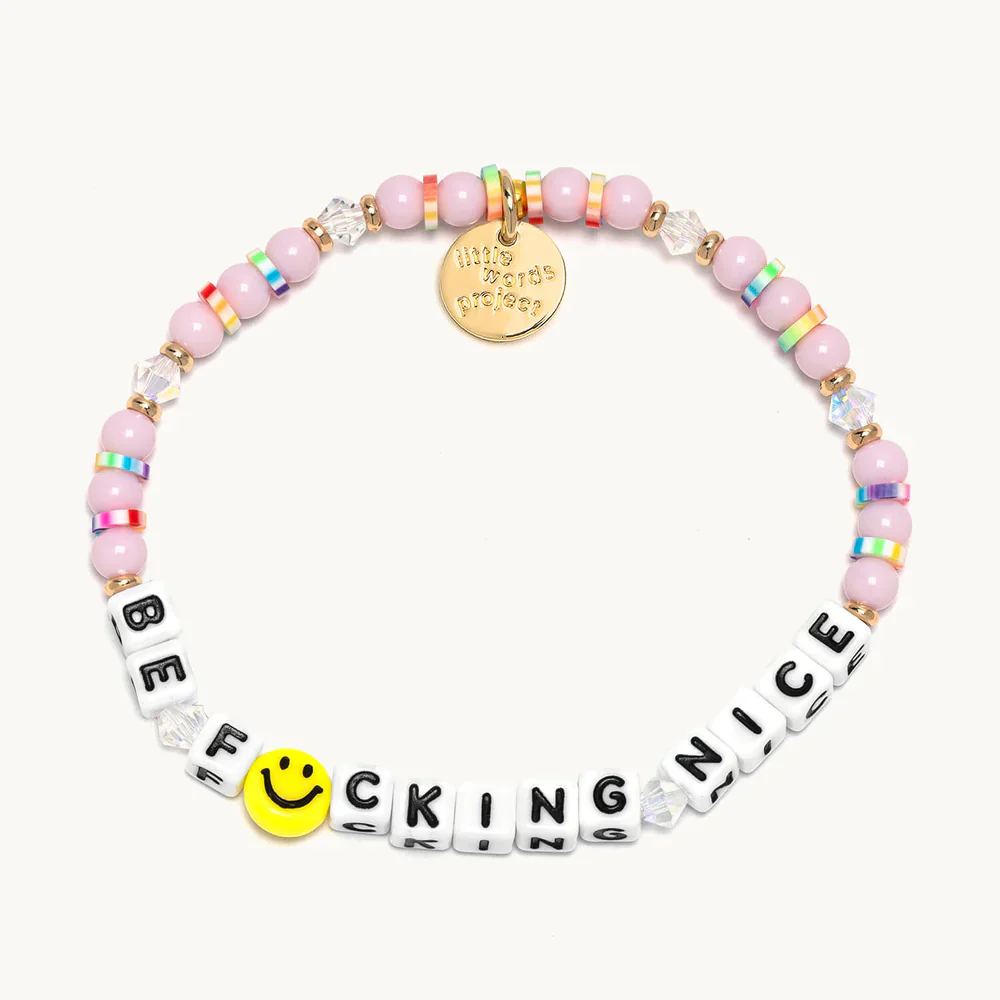 Pink bead bracelet from Little Words Project that reads, "Be Fucking Nice."