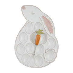 A Deviled Egg Tray in the shape of a Bunny, with a Carrot metal fork, designed by Mud Pie.