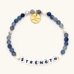 Blue bead bracelet that reads, "Strength."