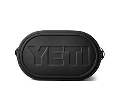 The bottom of a YETI Hopper M30 Soft Cooler in the color black, showing the word YETI.