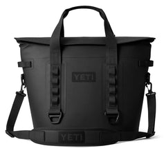 The new YETI Hopper M30 Soft cooler in the color black, showcasing the shoulder strap with a YETI logo on the top.