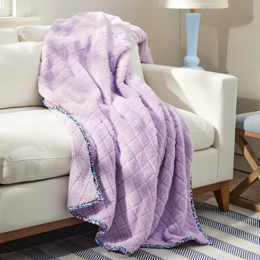 Vera Bradley Solid Throw Blanket Cloud Vine Multi, lying over a couch.