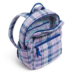 Vera Bradley Small Backpack In Amethyst Plaid Pattern with the side view of a drink pocket. The main pocket unzipped showing the internal fabric of the bag.