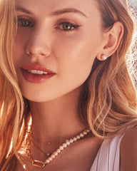 Ashton Pearl Stud Earrings In Gold White Pearl on a model.