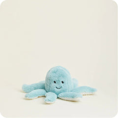 An adorable blue stuffed octopus waiting to be cuddled.