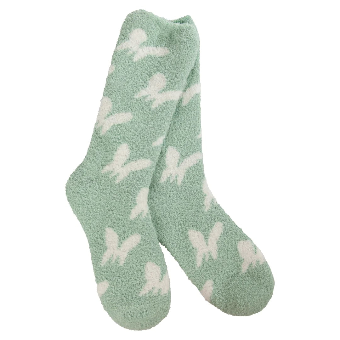 Women's cozy socks in the color green, with white butterflies from top to bottom.
