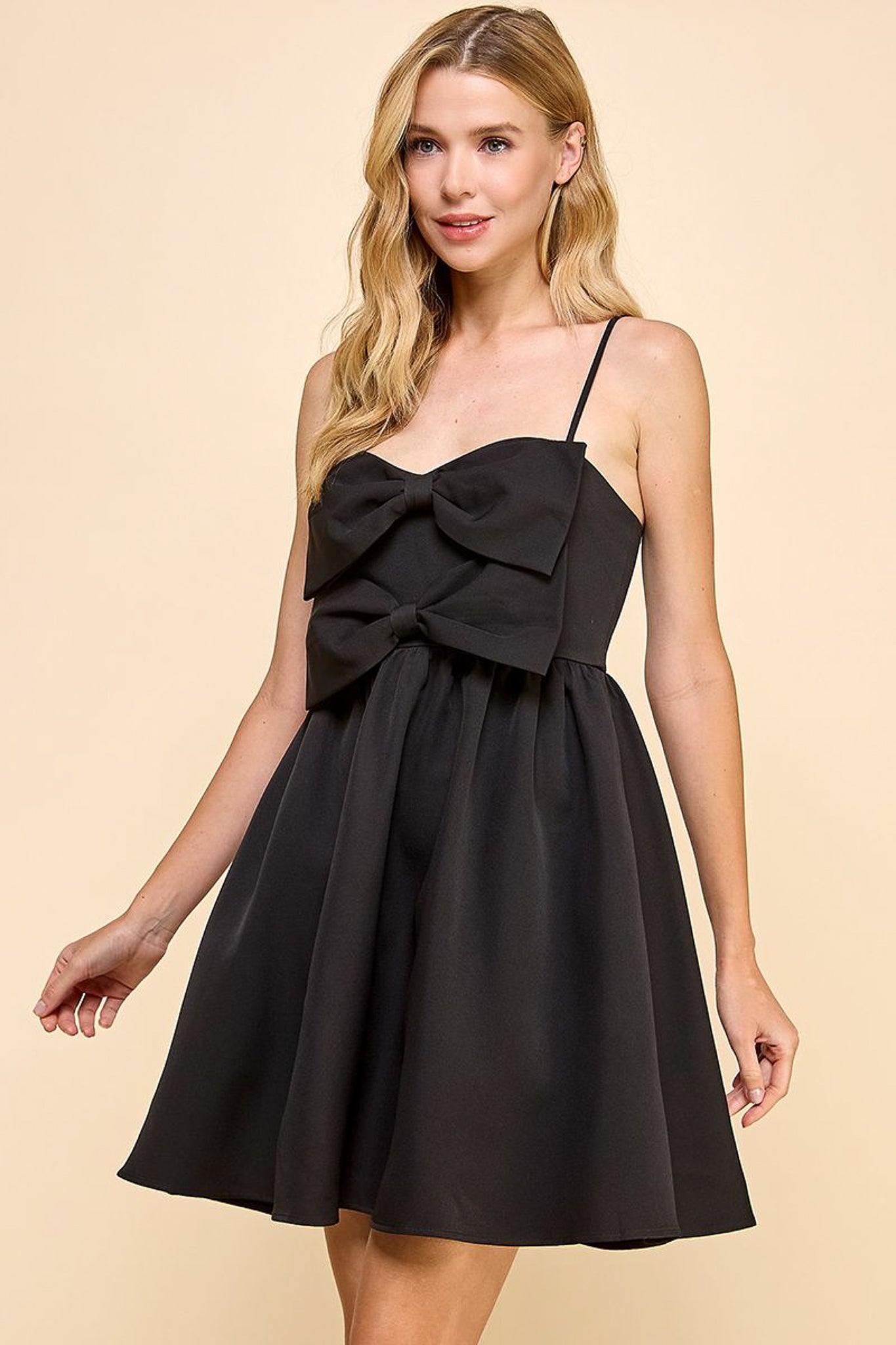 Angela Sleeveless Bow Dress in the color black.