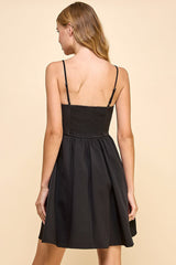 Angela Sleeveless Bow Dress in the color black.