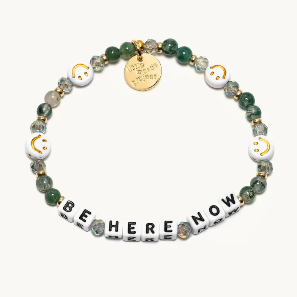 Green colored bead bracelet with white smiling faces, from Little Words Project. Be Here Now Bracelet.