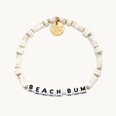 A white beaded bracelet that reads "beach bum."