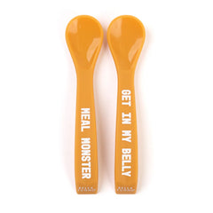 A set of 2 baby spoons in the color orange. One spoon reads, "Meal Monster." The other spoon reads, "Get In My Belly." This spoon set comes from the brand Bella Tunno.