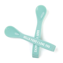 A set of 2 baby spoons in the color teal blue. One spoon reads, "Hello Food I Love You." The other spoon reads, "Baby Got Snacks." This spoon set comes from the brand Bella Tunno.