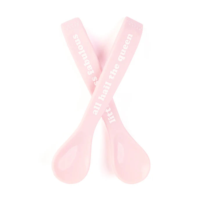 A set of 2 baby spoons in the color pink. One spoon reads, "All Hail The Queen." The other spoon reads, "Little Miss Fabulous ." This spoon set comes from the brand Bella Tunno.