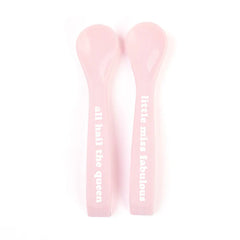 A set of 2 baby spoons in the color pink. One spoon reads, "All Hail The Queen." The other spoon reads, "Little Miss Fabulous ." This spoon set comes from the brand Bella Tunno.