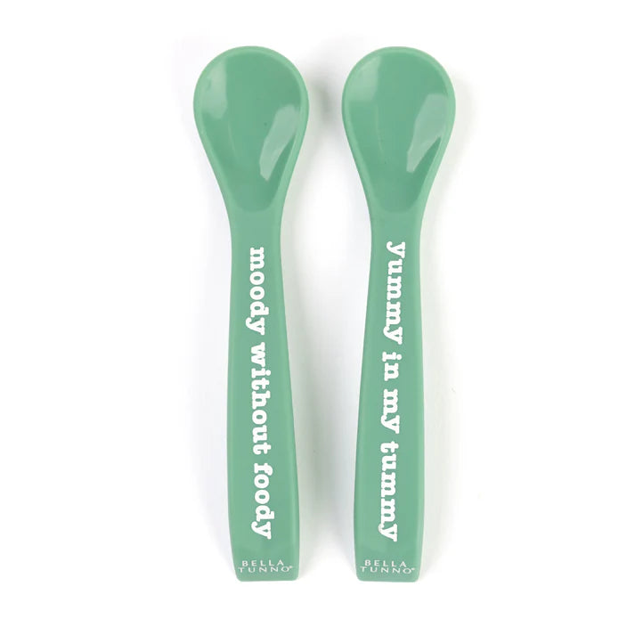 A set of 2 baby spoons in the color green. One spoon reads, "Yummy in my tummy." The other spoon reads, "moody without foody." This spoon set comes from the brand Bella Tunno.