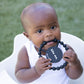 Black color Happy Teether that reads, "bite me" in the middle. The teether is made from silicone, and comes from the brand Bella Tunno.