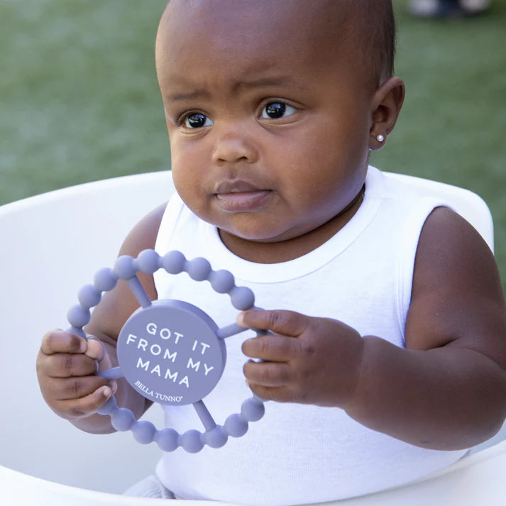 Grey color Happy Teether that reads, "GOT IT FROM MY MAMA" in the middle. The teether is made from silicone, and comes from the brand Bella Tunno.