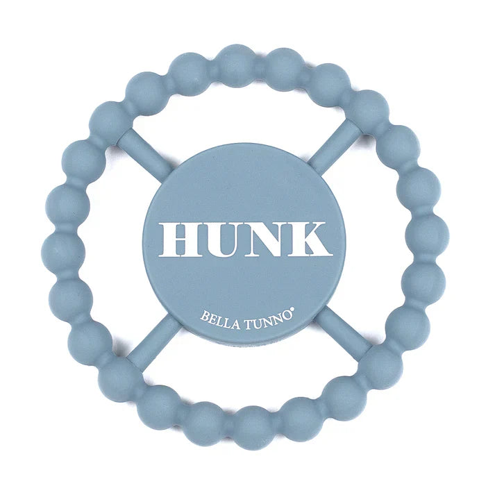Blue color Happy Teether that reads, "HUNK" in the middle. The teether is made from silicone, and comes from the brand Bella Tunno.