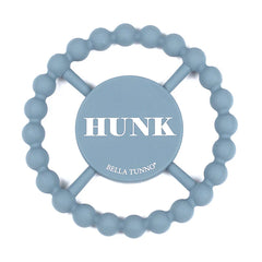 Blue color Happy Teether that reads, "HUNK" in the middle. The teether is made from silicone, and comes from the brand Bella Tunno.