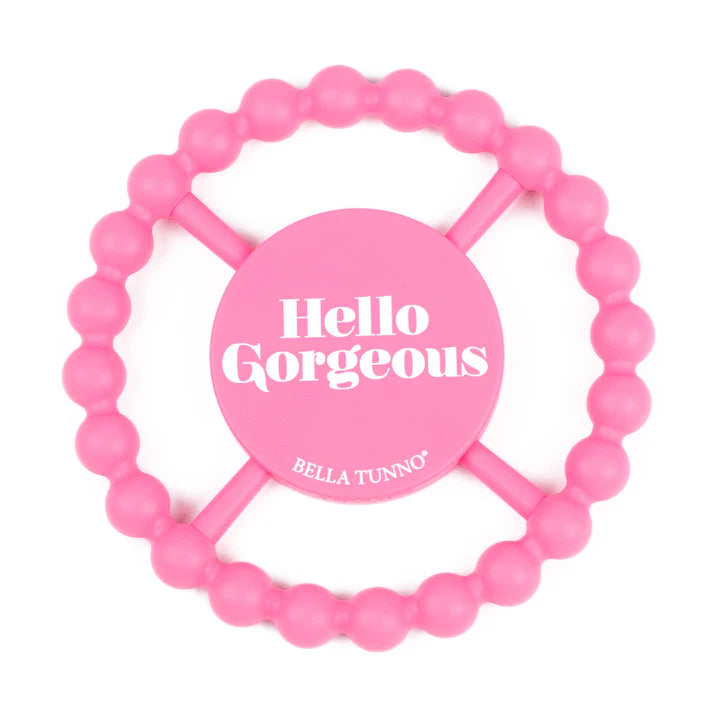 Pink color Happy Teether that reads, "Hello Gorgeous" in the middle. The teether is made from silicone, and comes from the brand Bella Tunno.