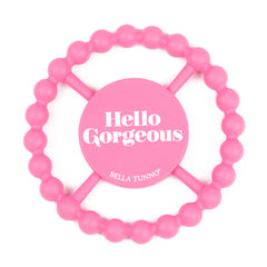 Pink color Happy Teether that reads, "Hello Gorgeous" in the middle. The teether is made from silicone, and comes from the brand Bella Tunno.