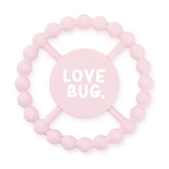 Pink color Happy Teether that reads, "LOVE BUG" in the middle. The teether is made from silicone, and comes from the brand Bella Tunno.