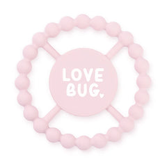 Pink color Happy Teether that reads, "LOVE BUG" in the middle. The teether is made from silicone, and comes from the brand Bella Tunno.