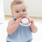 Pink color Happy Teether that reads, "LOVE BUG" in the middle. The teether is made from silicone, and comes from the brand Bella Tunno.