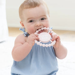 Pink color Happy Teether that reads, "LOVE BUG" in the middle. The teether is made from silicone, and comes from the brand Bella Tunno.