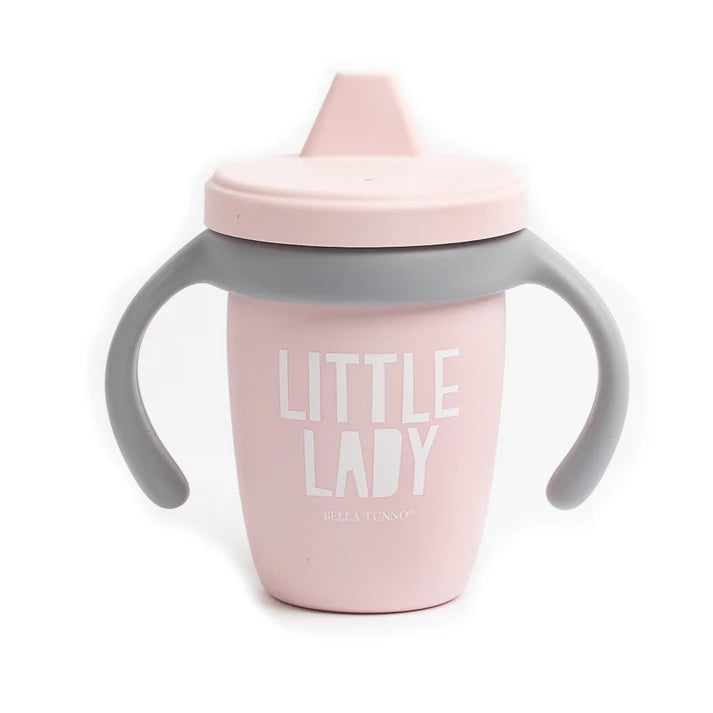 A pink color sippy cup, with gray handles. The sippy cup reads, "Little Lady" with the Bella Tunno logo at the bottom.