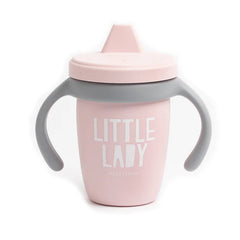 A pink color sippy cup, with gray handles. The sippy cup reads, "Little Lady" with the Bella Tunno logo at the bottom.