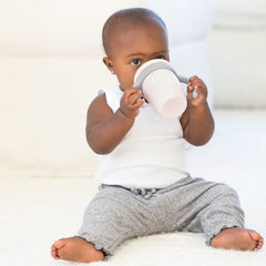 A pink color sippy cup, with gray handles. The sippy cup reads, "Little Lady" with the Bella Tunno logo at the bottom.