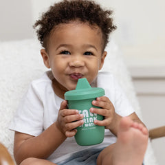 A green color sippy cup, with gray handles. The sippy cup reads, "Tall Drink of Water" with the Bella Tunno logo at the bottom.