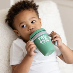 A green color sippy cup, with gray handles. The sippy cup reads, "Tall Drink of Water" with the Bella Tunno logo at the bottom.