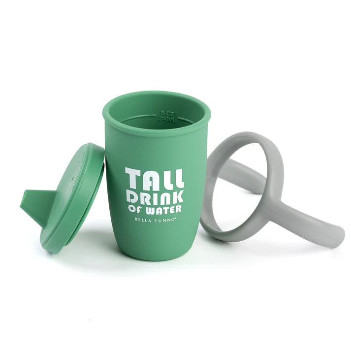 A green color sippy cup, with gray handles. The sippy cup reads, "Tall Drink of Water" with the Bella Tunno logo at the bottom.