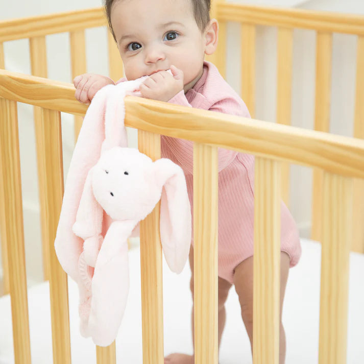 A pink bunny teether, with two teething rings on it's paws. The bunnies name is Betty, and comes from the brand Bella Tunno.