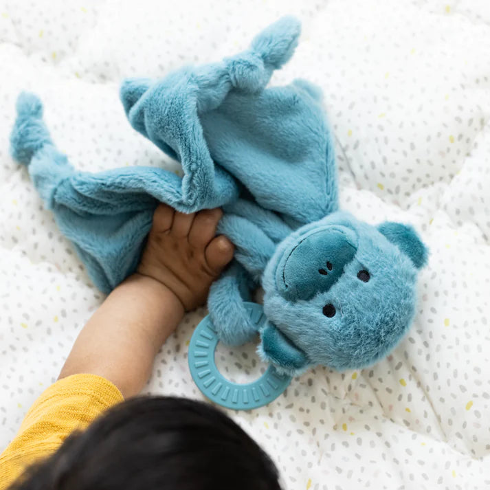 A blue monkey teether, with two teething rings on it's paws. The bunnies name is Milo, and comes from the brand Bella Tunno.