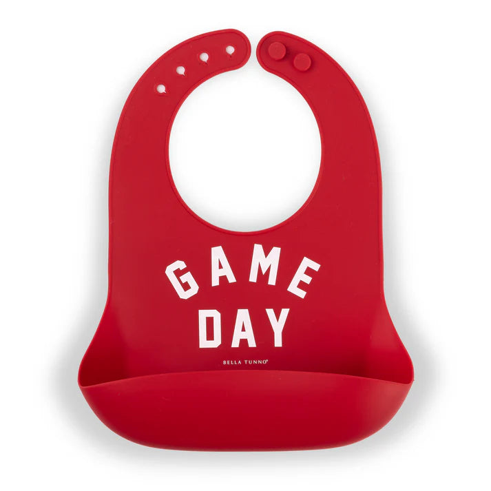 Red color Wonder Bib that reads, "Game Day" with the Bella Tunno logo below it. The bib is adjustable in size with 4 snaps that easily fit around the neck. The Wonder Bib is designed out of silicone, and is made by Bella Tunno.