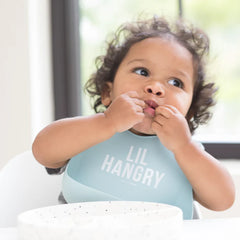 Blue color Wonder Bib that reads, "Lil Hangry" with the Bella Tunno logo below it. The bib is adjustable in size with 4 snaps that easily fit around the neck. The Wonder Bib is designed out of silicone, and is made by Bella Tunno.