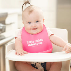 Pink color Wonder Bib that reads, "little miss fabulous" with the Bella Tunno logo below it. The bib is adjustable in size with 4 snaps that easily fit around the neck. The Wonder Bib is designed out of silicone, and is made by Bella Tunno.