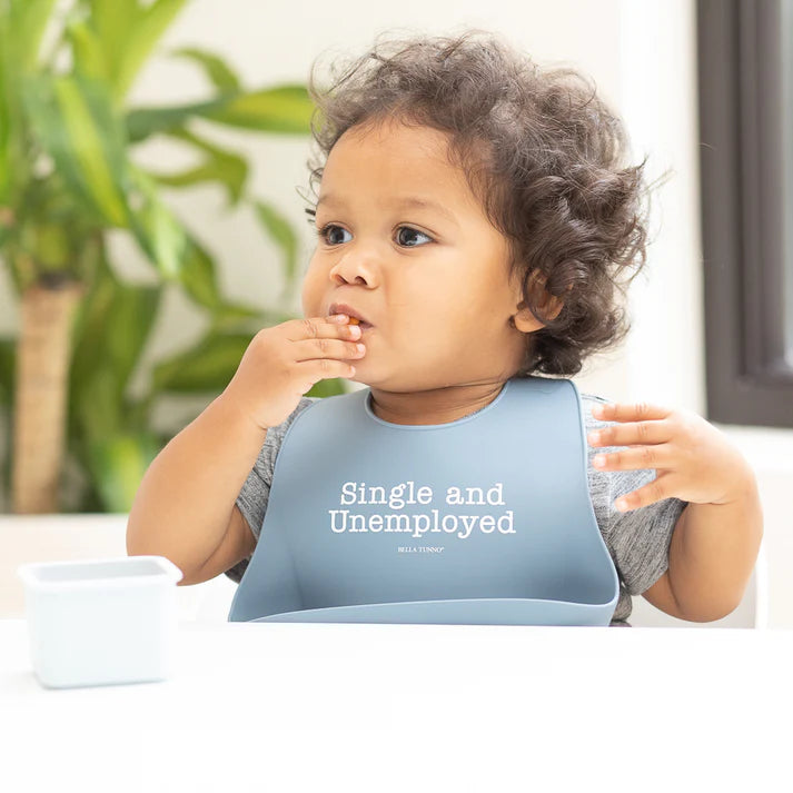 Blue color Wonder Bib that reads, "Single and Unemployed" with the Bella Tunno logo below it. The bib is adjustable in size with 4 snaps that easily fit around the neck. The Wonder Bib is designed out of silicone, and is made by Bella Tunno.