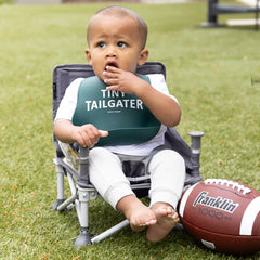 Green color Wonder Bib that reads, "Tiny Tailgater" with the Bella Tunno logo below it. The bib is adjustable in size with 4 snaps that easily fit around the neck. The Wonder Bib is designed out of silicone, and is made by Bella Tunno.