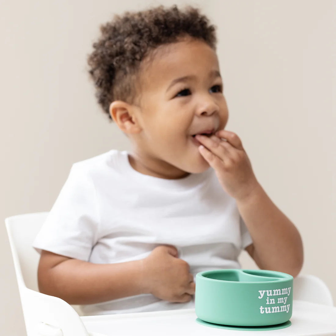 A Bella Tunno Wonder Bowl for kids in the color green that reads, "Yummy in My Tummy." 