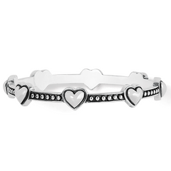 Silver bangle bracelet featuring heart charms all around the bracelet. Designed by Brighton Designs.