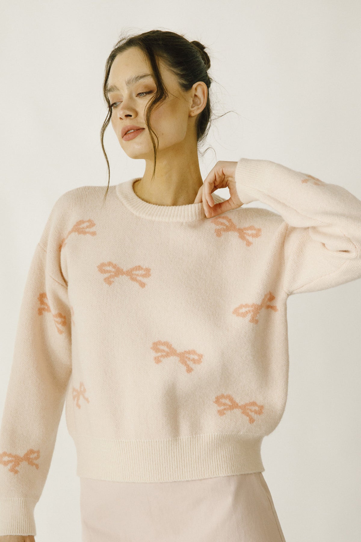 Daisy Mercantile Bow Knit Sweater, with pink ribbons all around the sweater.