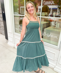 A green summer dress with white stripes at the bottom.