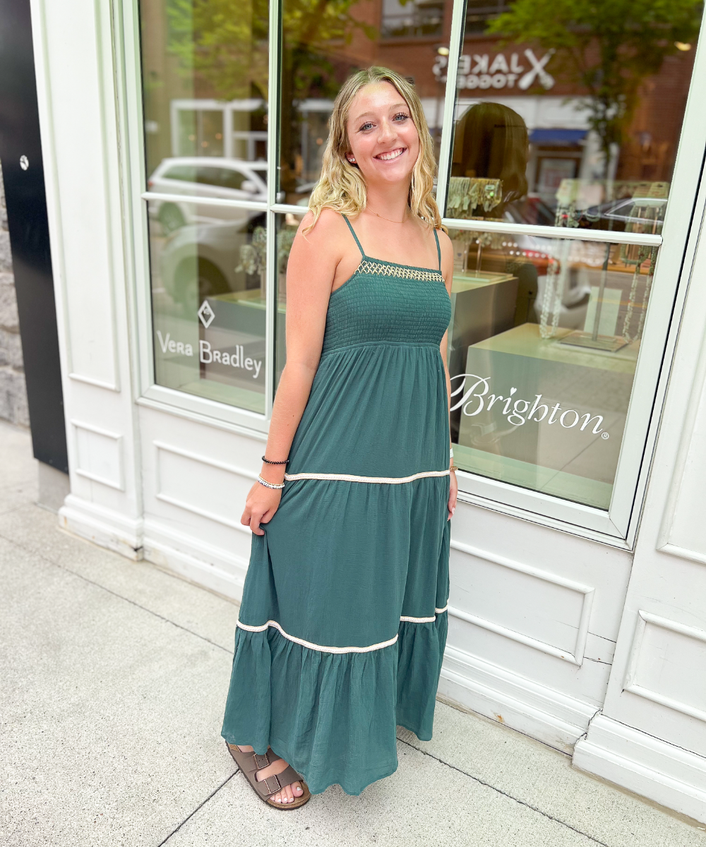 A green summer dress with white stripes at the bottom.