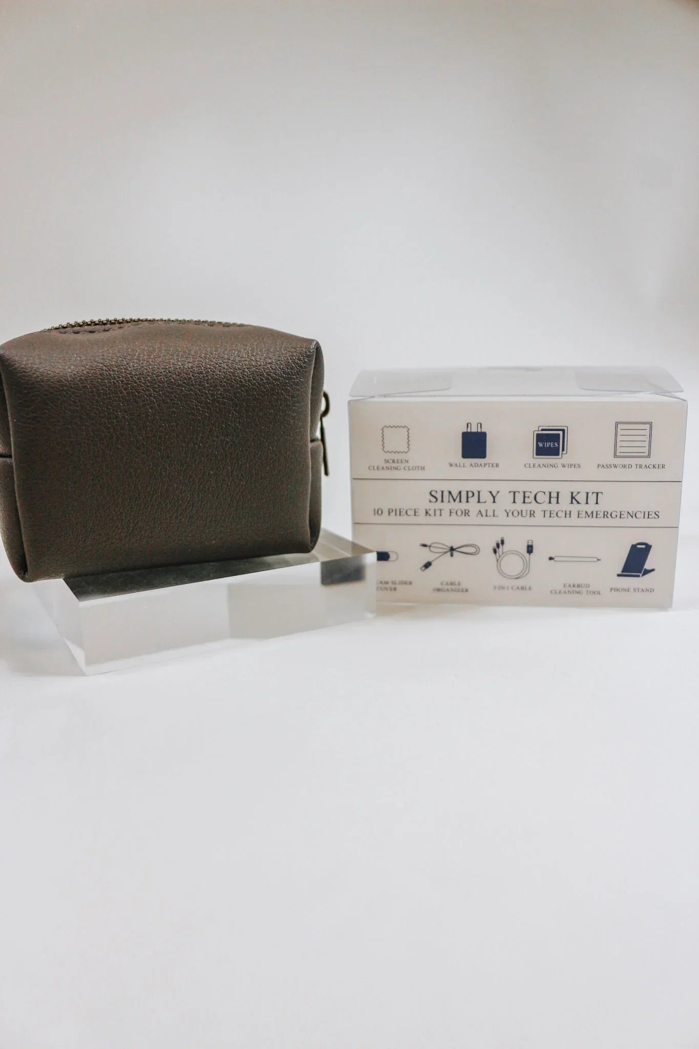 Dark Grey simply tech kit, a. 10 pice kit for all your tech emergencies. Carry screen cleaning clothes, wall adapters, cleaning wipes, password trackers, webcam slider covers, cables, earbud cleaners, and phone stands.