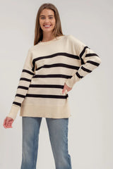 White women's sweater with 5 black stripes.