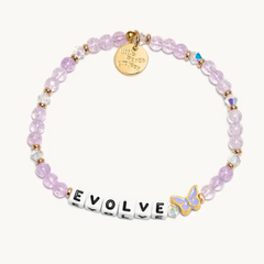 Purple bead bracelet from Little Words Project, with a purple butterfly, and the word "EVOLVE."